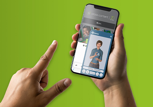 Mão com o indicador esticado se aproxima da tela de celular exibindo o site da Cross Content e, sobre ele, em parte da tela, o aplicativo da Rybená com o desenho em animação 3D da personagem que faz a leitura de libras